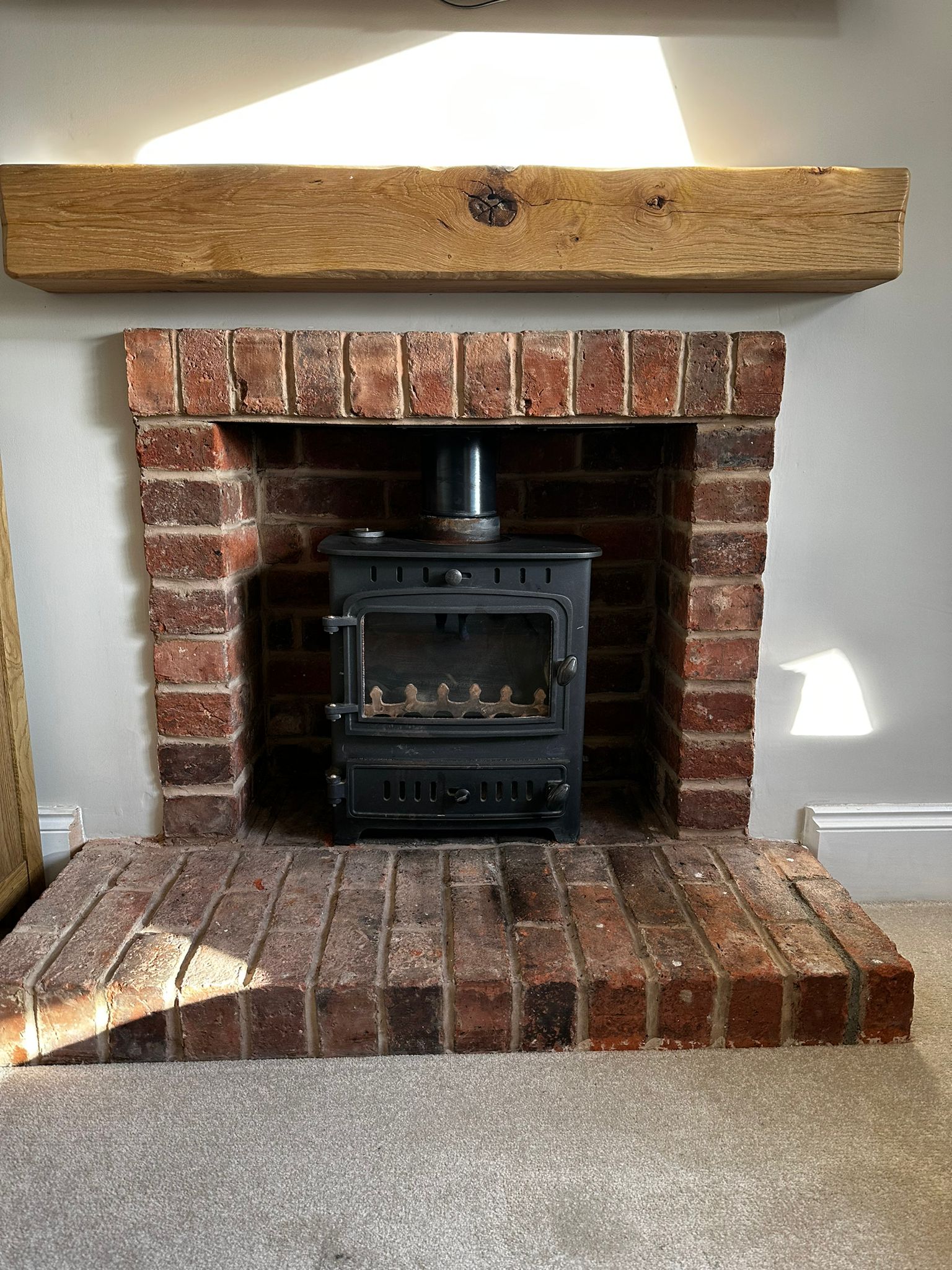 Authentic brick fireplace with log burner